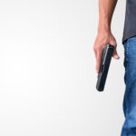 Person holding gun to the side of their body